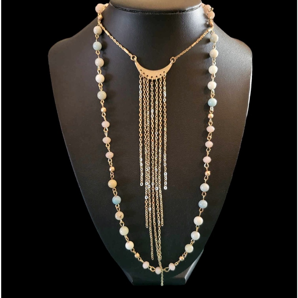 Multilayered gold tone necklace with stone and beads.